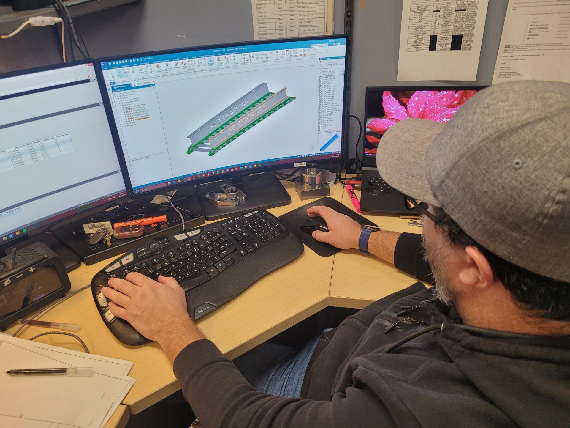 Engineer working in SolidWorks designing a custom metal part