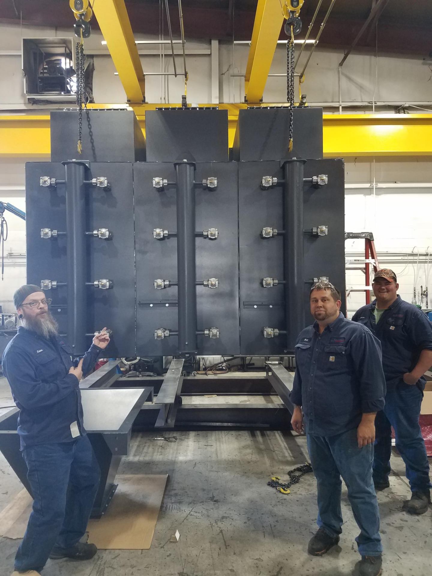 CMF fabrication team with large industrial equipment assembly