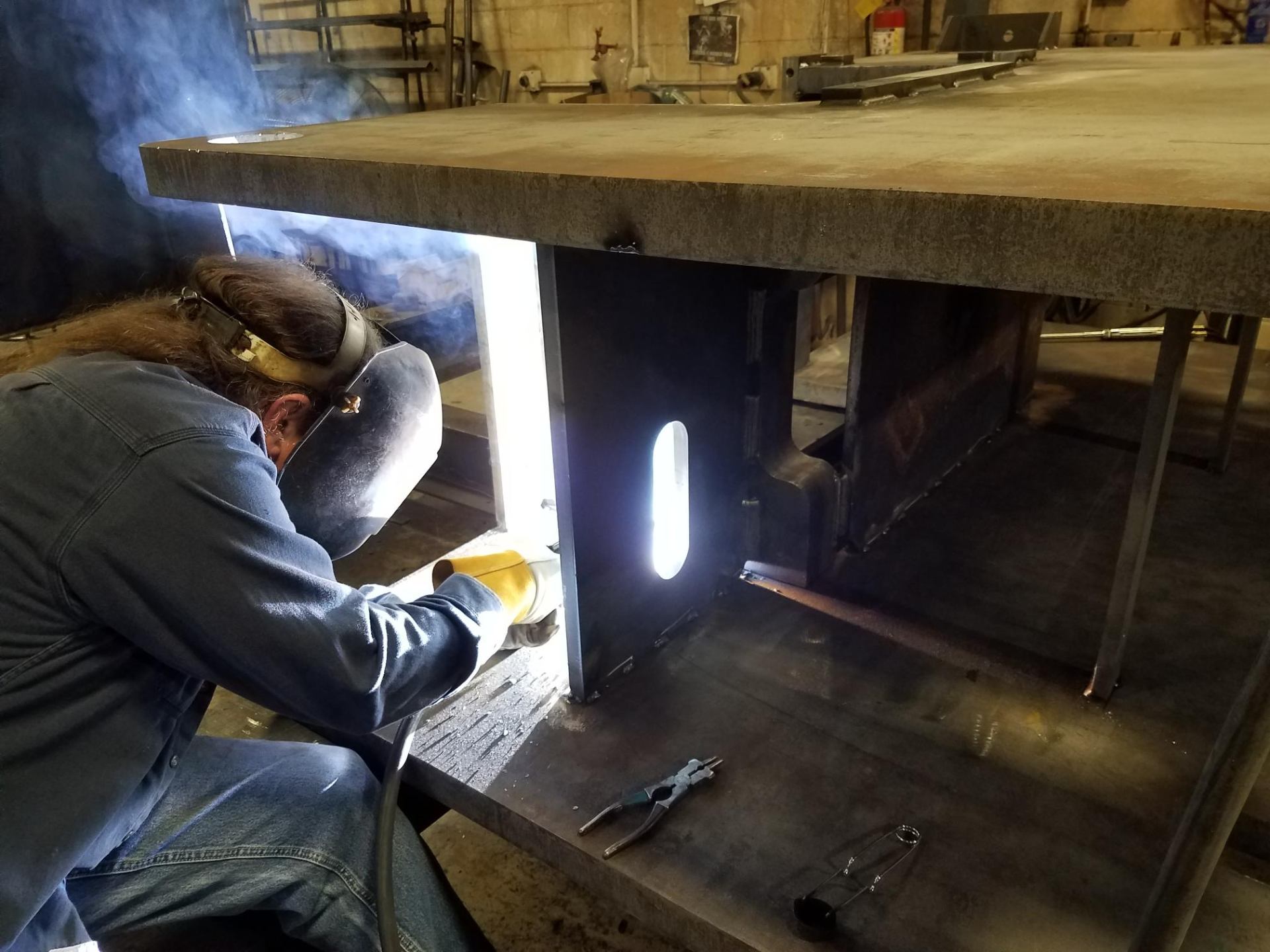 CMF welder welding a steel fabrication with sparks flying