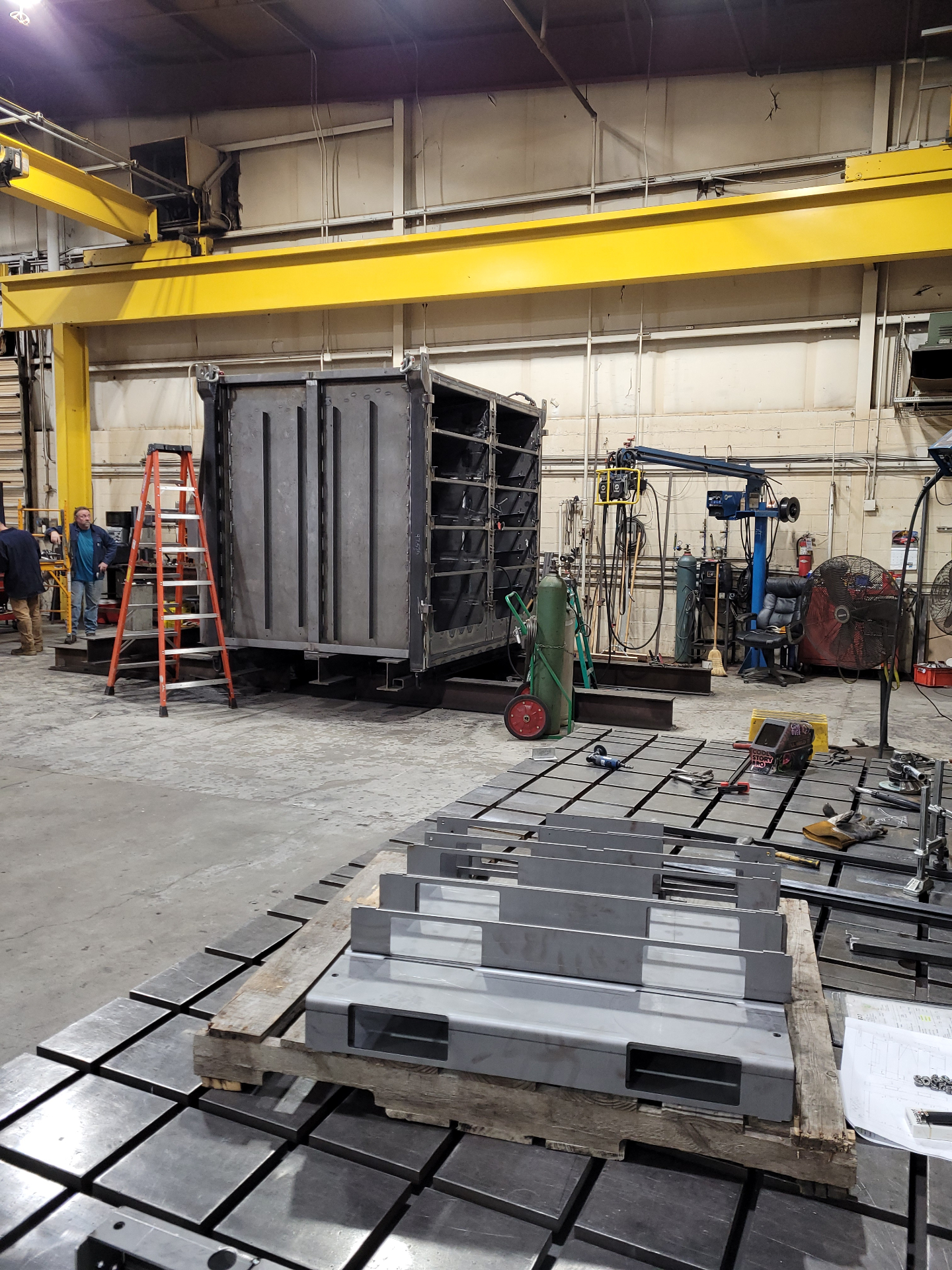 Heavy fabrication with overhead crane showing capital equipment investment
