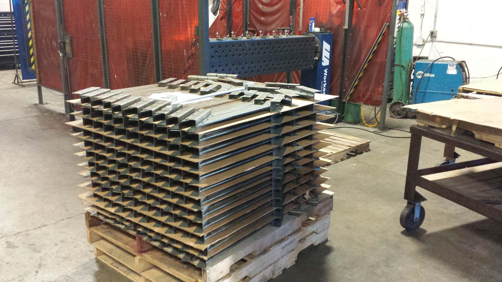 Stack of fabricated robot base components ready for assembly